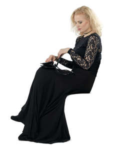 woman in a formal black dress sitting