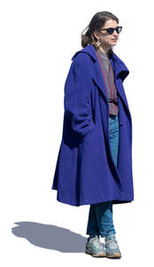 woman in a blue overcoat standing