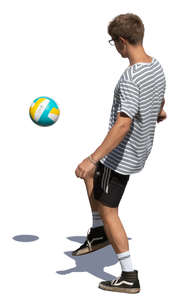 young man juggling a football ball