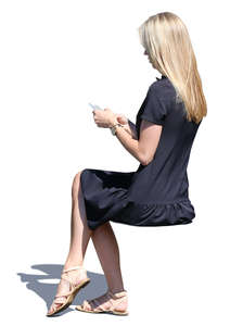 woman in a black summer dress sitting