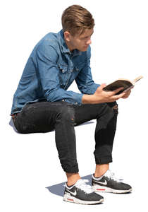 young man sitting and reading a book