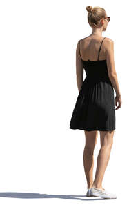 sidelit woman in a black summer dress standing