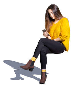 young woman sitting and texting