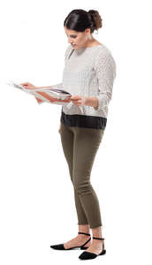 woman standing and reading a newspaper