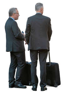 two businessmen with suitcases standing