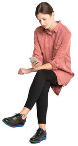woman sitting and looking at her phone