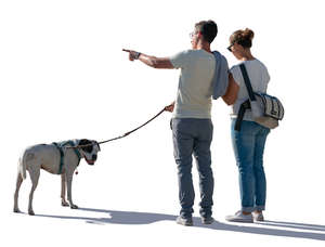 backlit couple with a dog