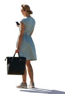 woman in a light blue summer dress standing