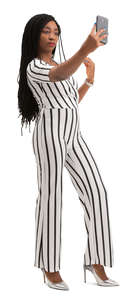 black woman in a striped jumpsuit taking a selfie