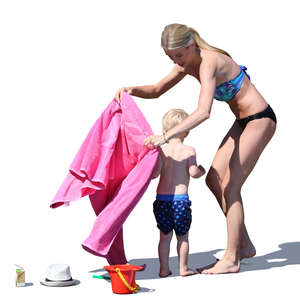 mother drying her son on the beach