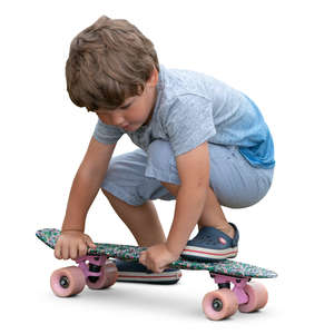 little boy playing with skateboard