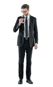 man in a suit drinking wine