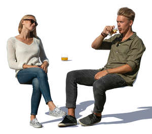 man and woman sitting in a cafe on a sunny day