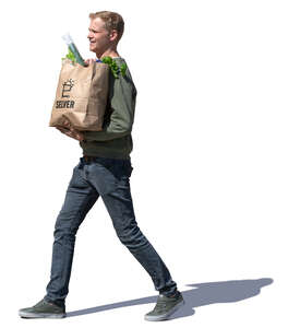 man with a grocery bag walking