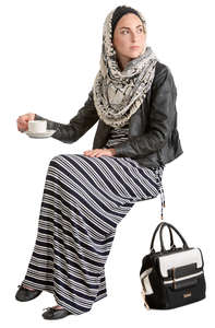 muslim woman sitting in a cafe