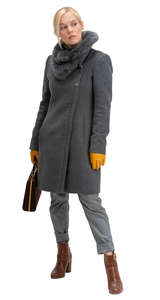 woman in a grey overcoat standing