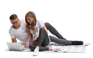 couple lying on the blanket and watching videos.