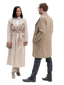 man and woman in overcoats standing and talking