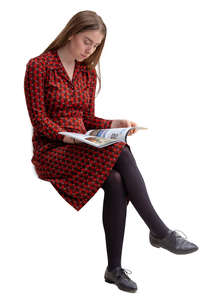 young woman sitting and reading a magazine