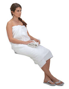 woman wrapped in spa towel sitting