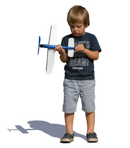 little boy playing with a toy plane