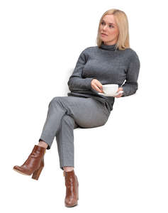 woman sitting and drinking coffee