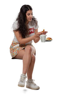 woman eating a bun in a cafe