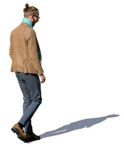 man in a light brown jacket walking