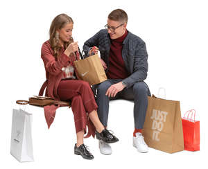 man and woman with shopping bags sitting