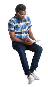 black man sitting and reading a book