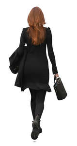 red haired woman ina a black dress walking