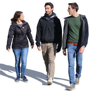 group of three people walking and talking