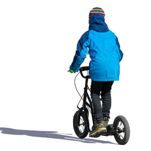boy in autumn riding a scooter