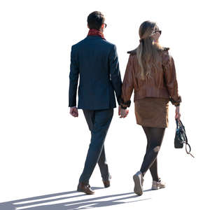 man and woman walking hand in hand on a spring day