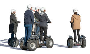 group of adults riding segways