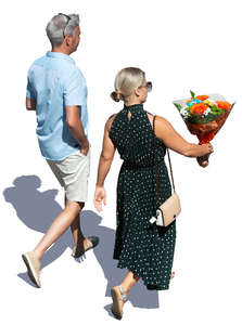 man and woman walking and carrying flowers seen from above