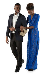 black man and woman in formal outfits walking arm in arm