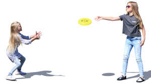 two girls playing frisbee