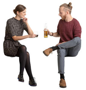 young man and woman sitting and talking in a cafe