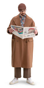 man in a brown overcoat standing and reading a newspaper