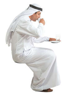 arab man sitting and drinking coffee