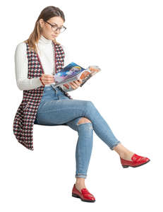 woman sitting and reading a magazine