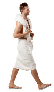 man in a white towel walking