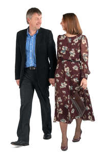 middle aged couple walking hand in hand