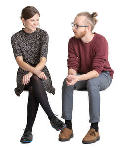 man and woman sitting and talking