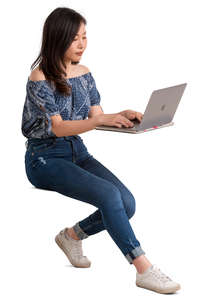 young asian woman sitting behind a desk