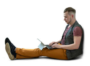 man sitting on the floor and working on a tablet