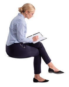 woman in an office sitting and writing