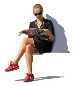 woman sitting on a bench and reading a magazine