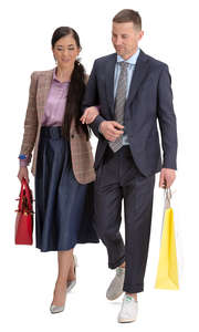 man and woman with shopping bags walking arm in arm